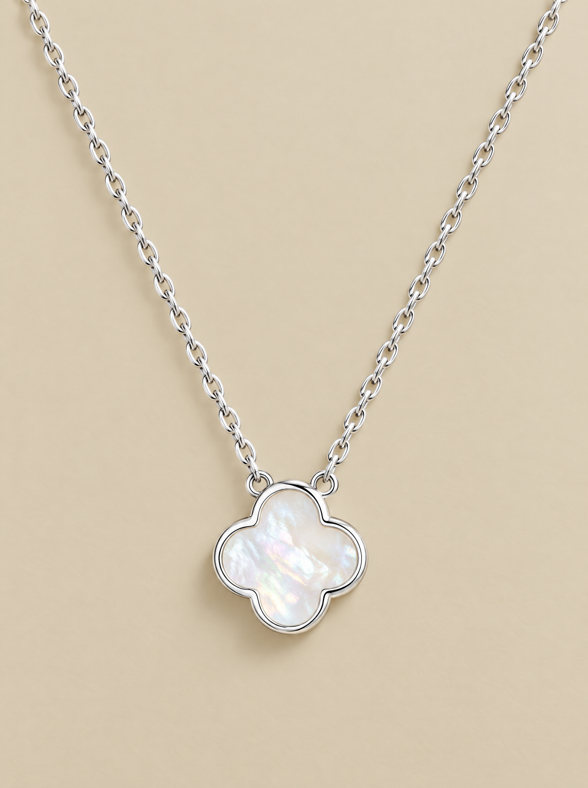 White Pearl Clover Necklace on a beige background