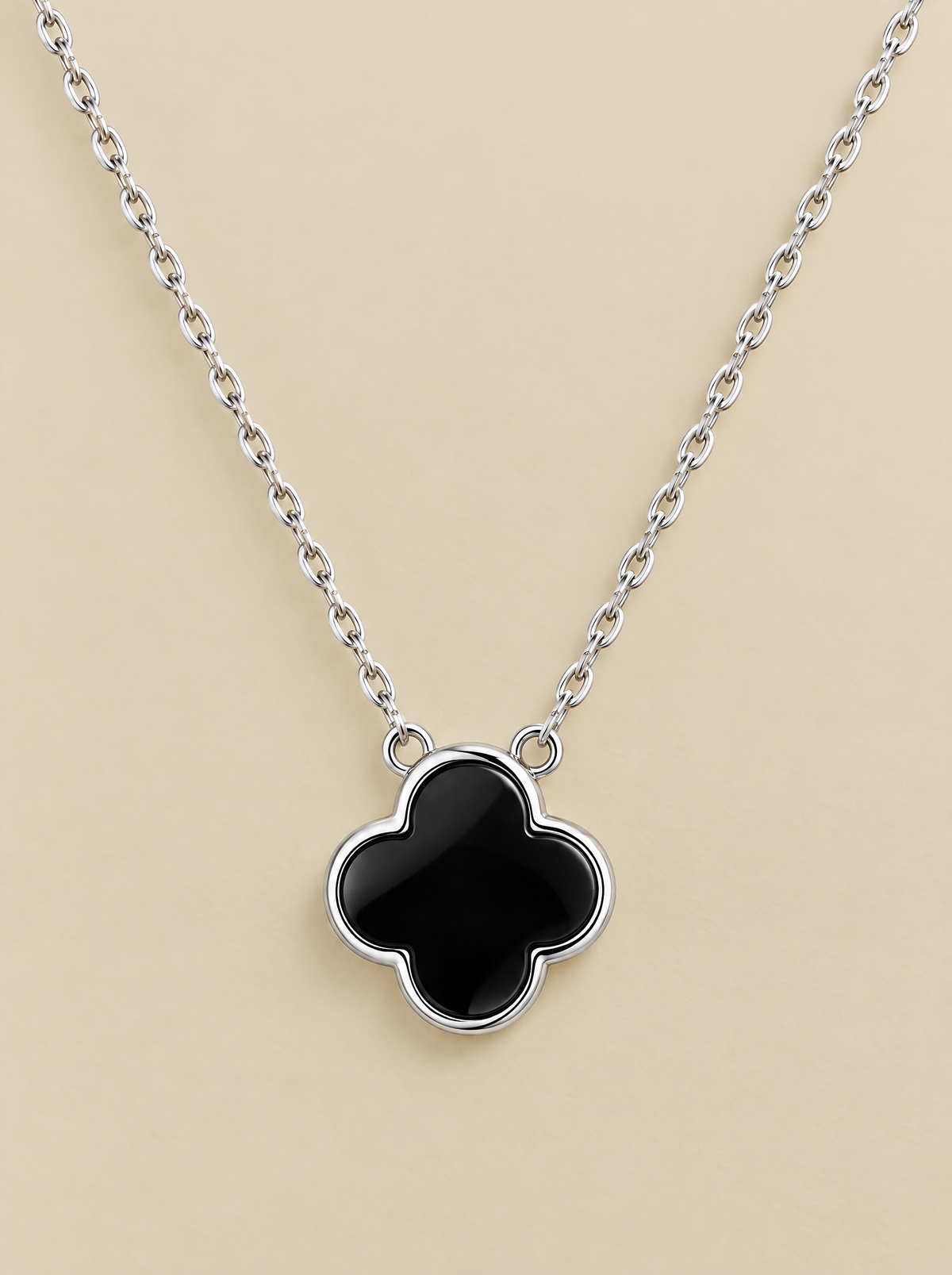 Black Onyx Clover Necklace on a beige background
