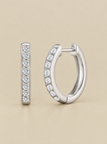 Sparkle Huggie Hoop Earrings on a beige background