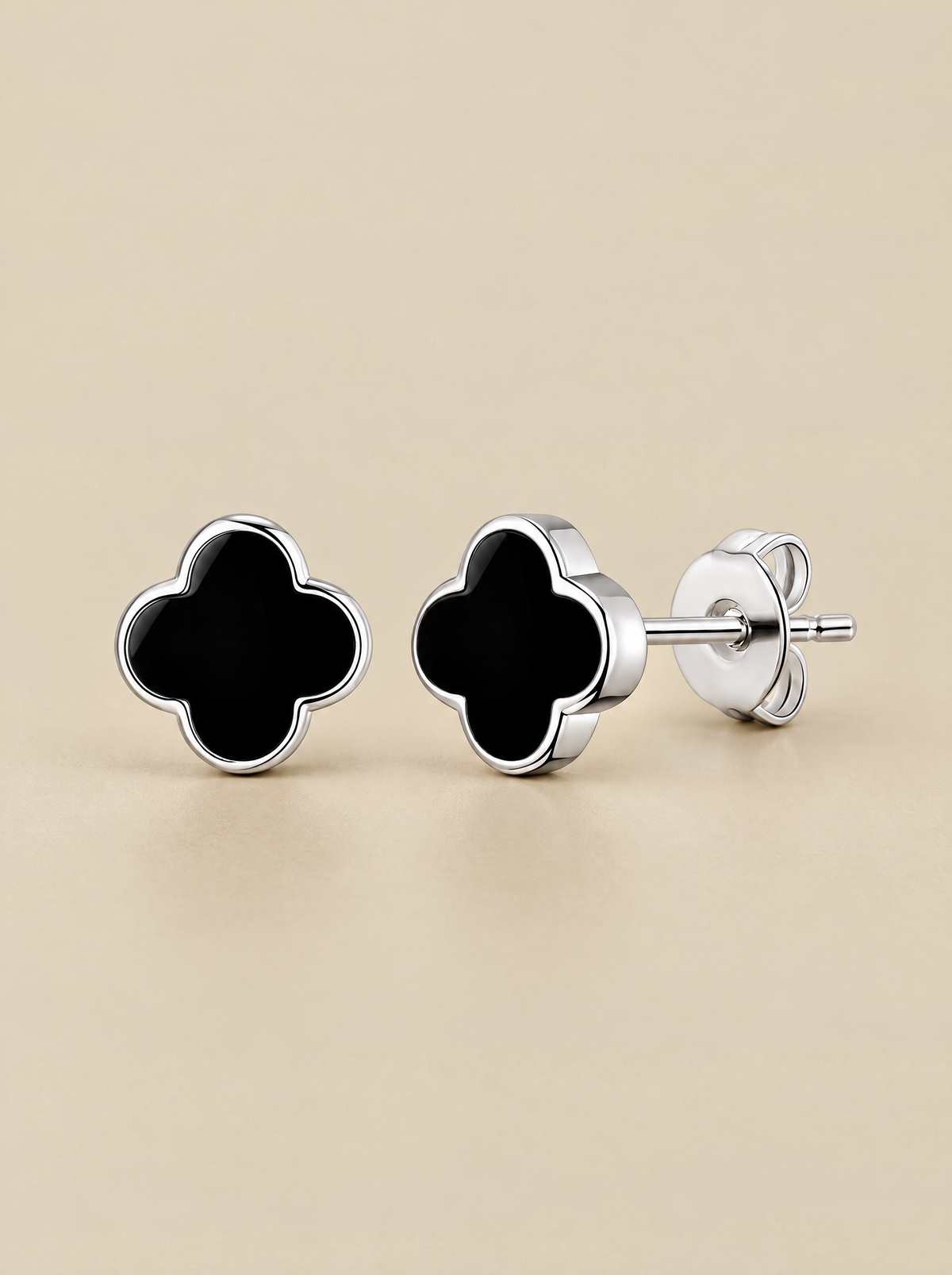 Black Onyx Clover Stud Earrings on a beige background