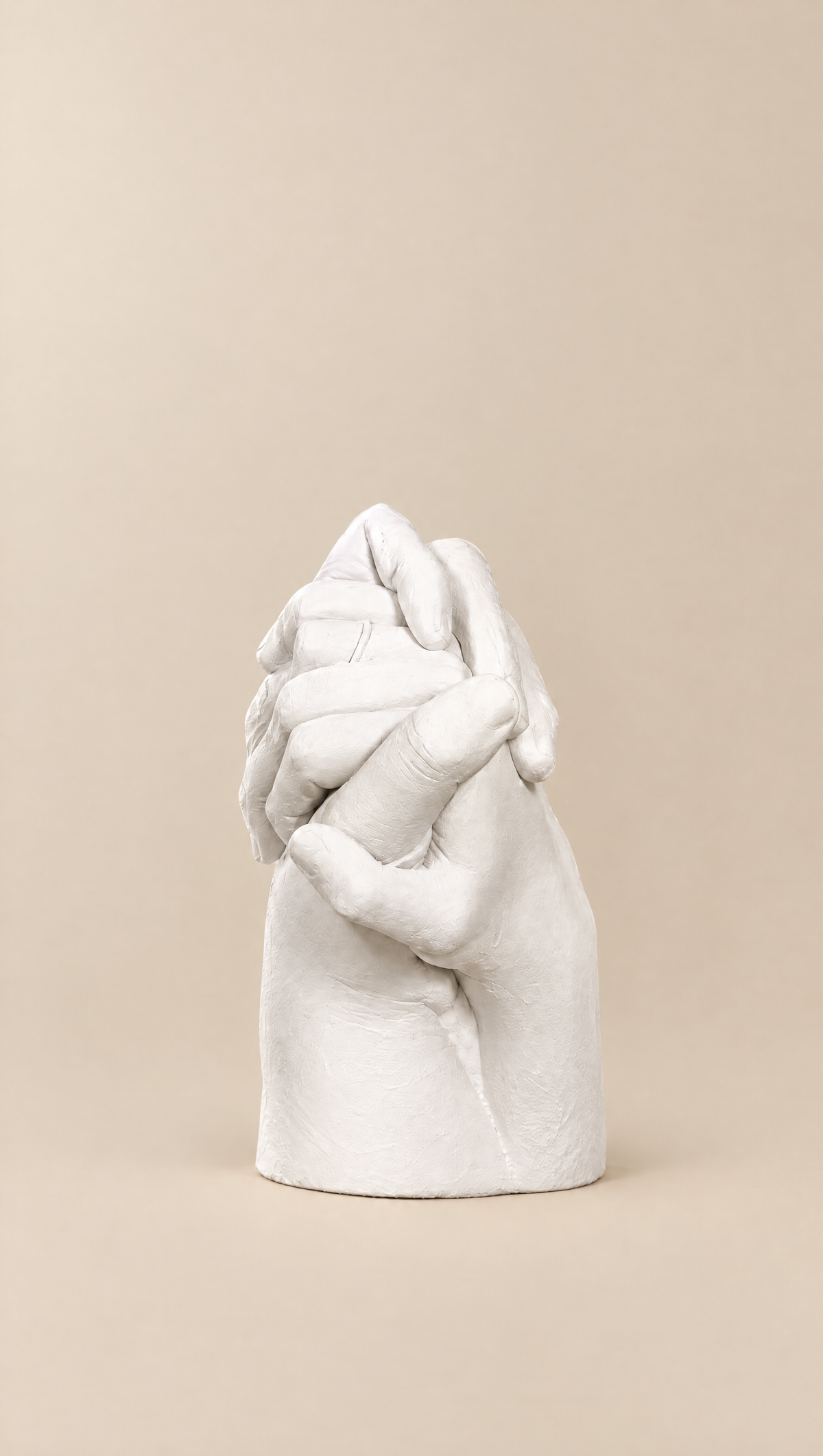 Couple hand casting sculpture on a beige background